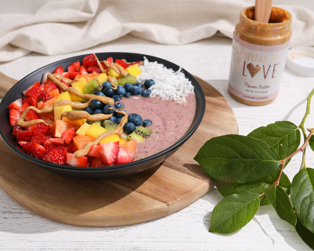 Rainbow Superfood Smoothie Bowl with jar of Almond Cashew Butter