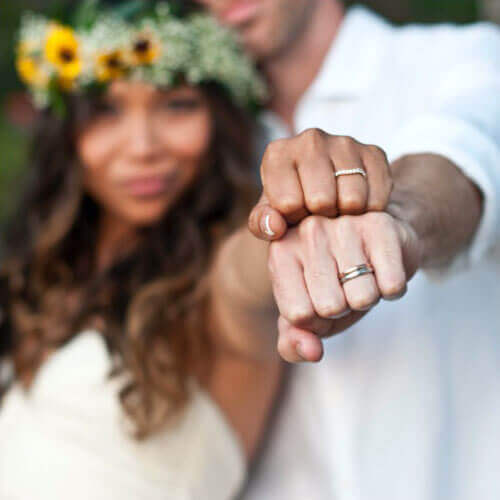 Zach and Val on their wedding day showing their wedding rings