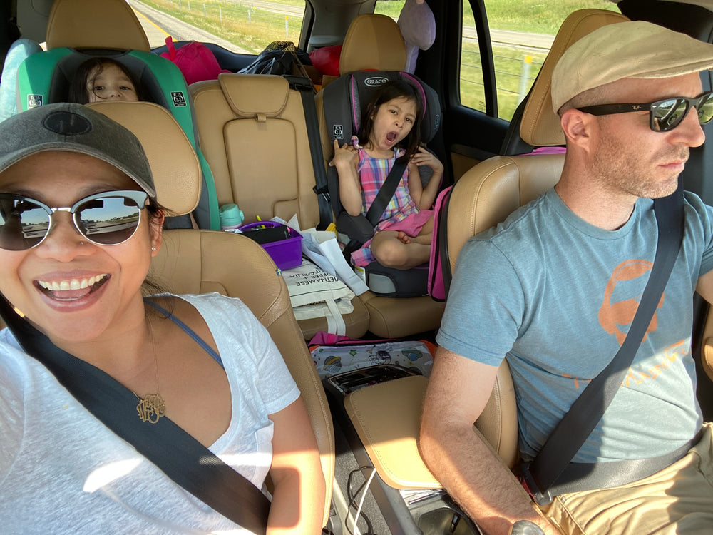 Fishbain Family road trip with kids in car seats and parents in front.