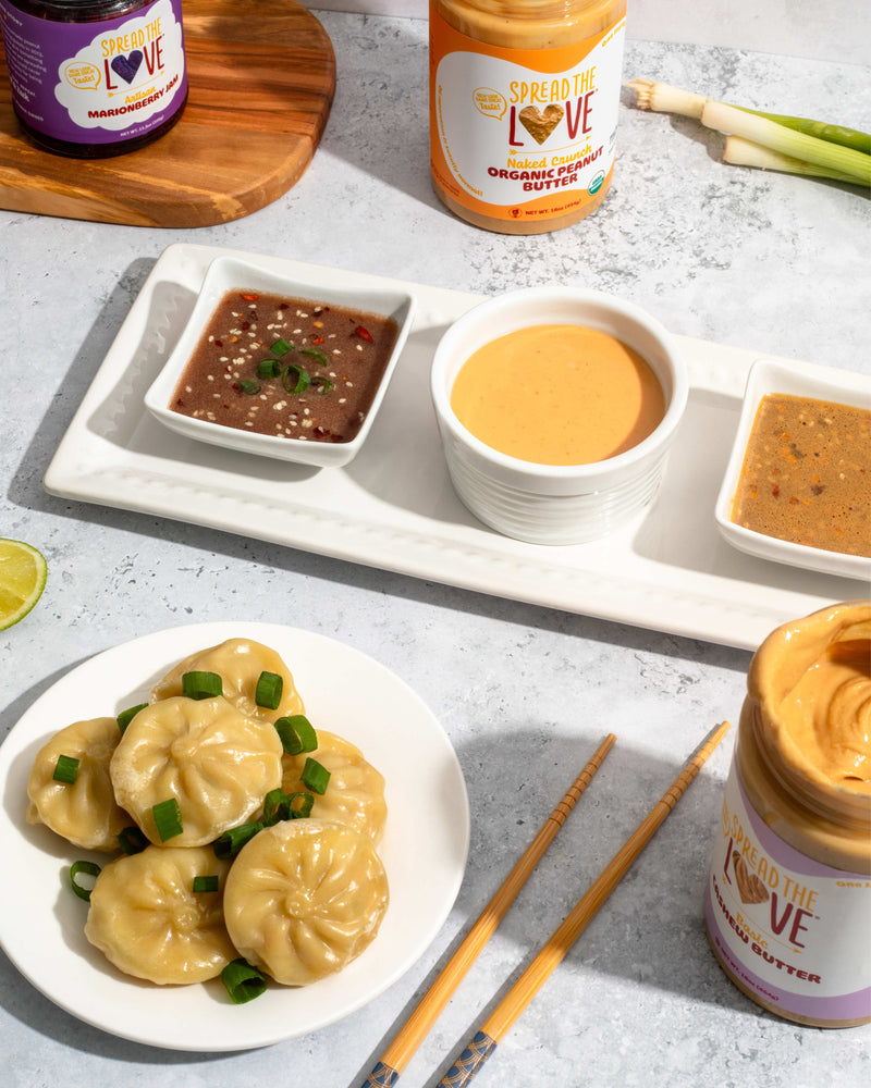 Plate of dumplings with sauce trio and Spread The Love products