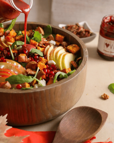 Bowl of Fall Salad with Raspberry Vinaigrette drizzled on top
