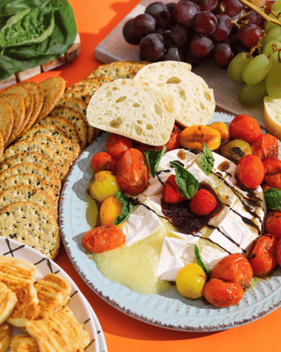 Plate with Fried Brie, tomatoes, crackers, and grapes