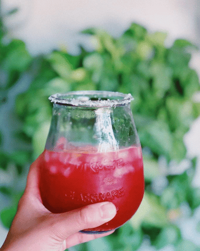 Glass of Raspberry Jam Margarita with a salt rim