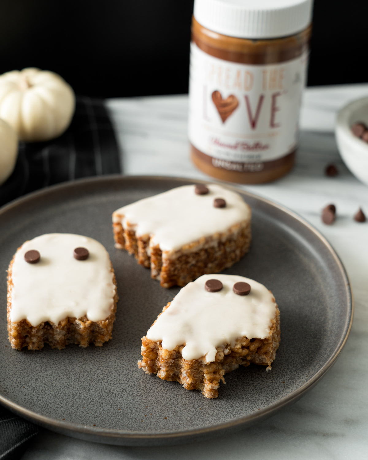 Plate of Almond butter Crispy Treat Ghosts with Spread The Love Almond Butter in the background