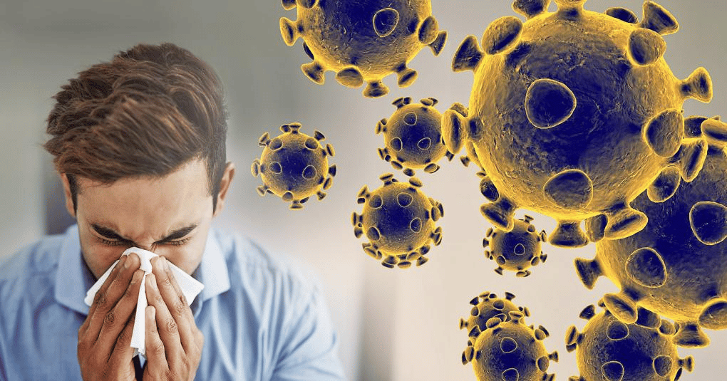 Someone sneezing into tissue with germ cells.
