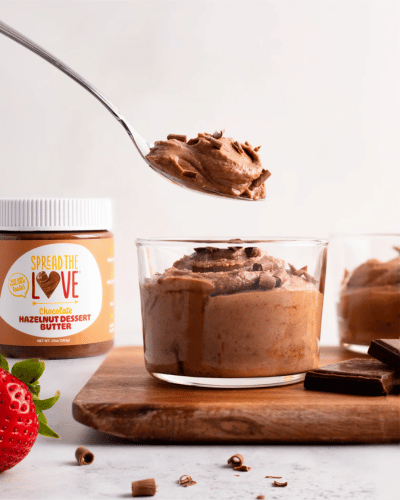 Glass container of Chocolate Hazelnut Coconut Cream Mousse with spoon scooping out