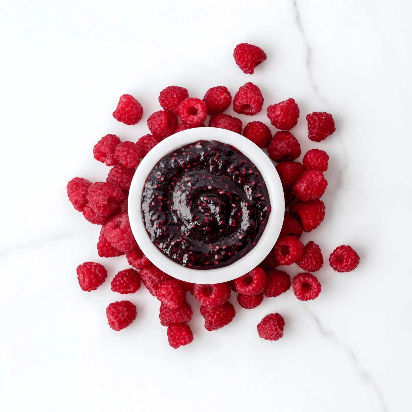 Spread The Love RASPBERRY Jam on a table showing texture of the product