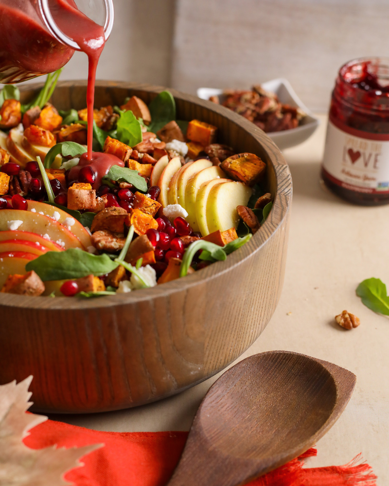 Bowl of Fall Salad with Raspberry Vinaigrette drizzled on top