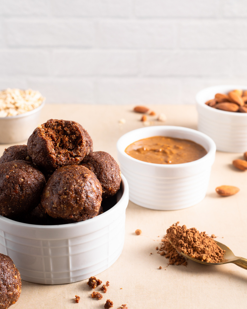 Bowl of chocolate almond butter date balls and bowl of almond butter