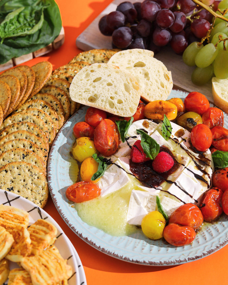 Plate with Fried Brie, tomatoes, crackers, and grapes