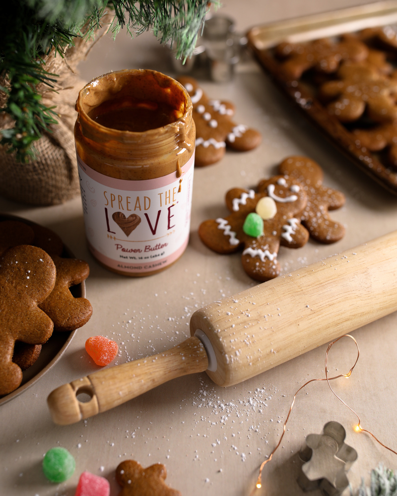 Decorated Almond Cashew Gingerbread Cookies with Almond Cashew Power Butter Jar and rolling pin