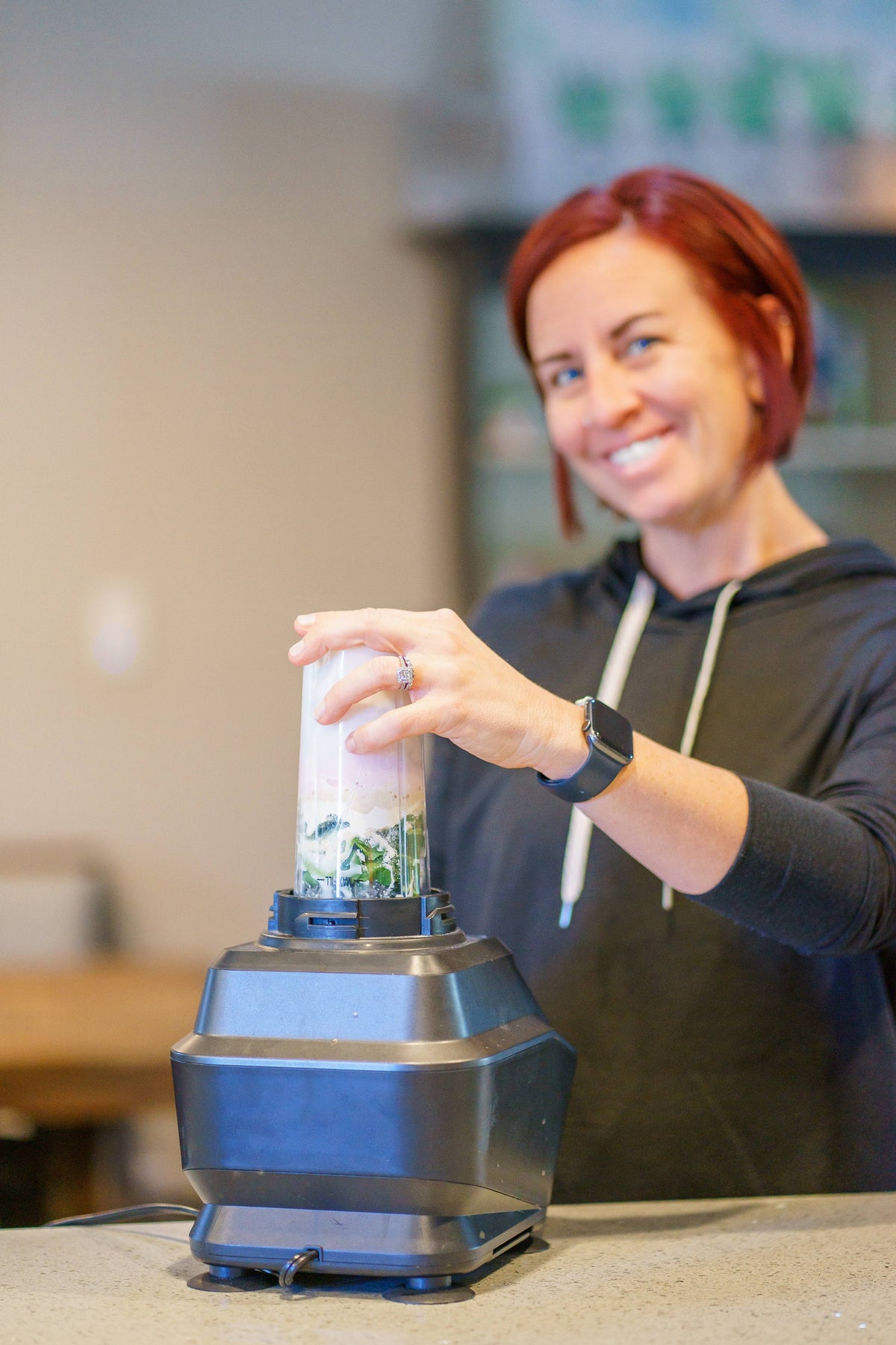 Kaley Bowden  blending a fruit and spinach smoothie for a healthy lunchbox addition.