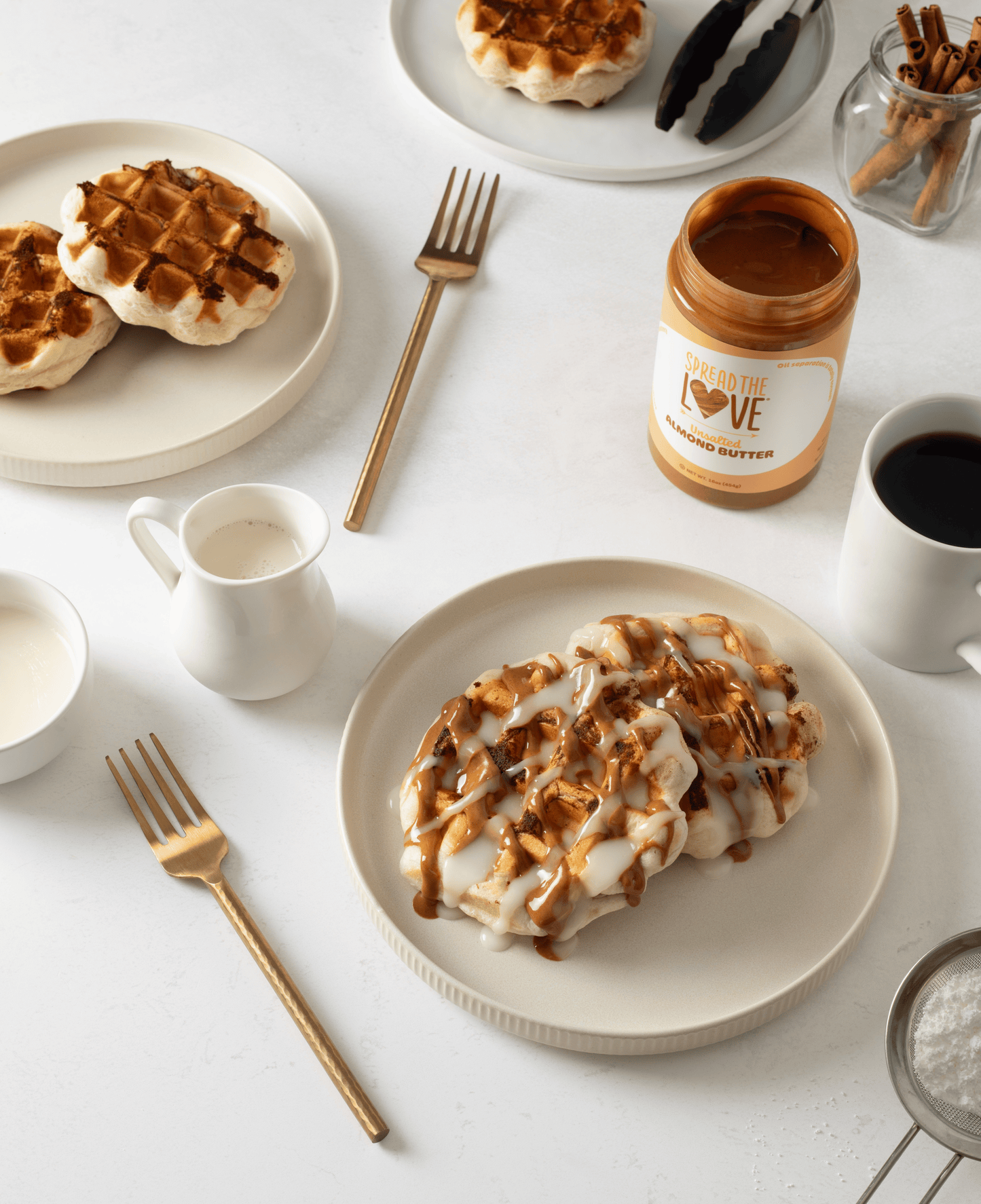 Cinnamon Roll Waffles on plates with Almond Butter Jar