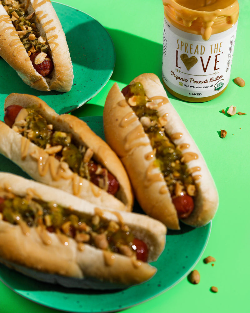 Plate full of Hot Dogs with relish and peanut butter drizzle 