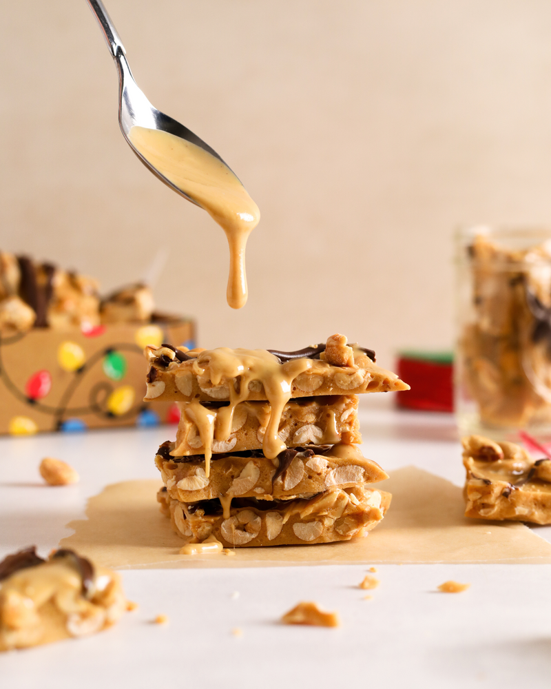 Stack of Peanut Brittle with Peanut Butter drizzle on top