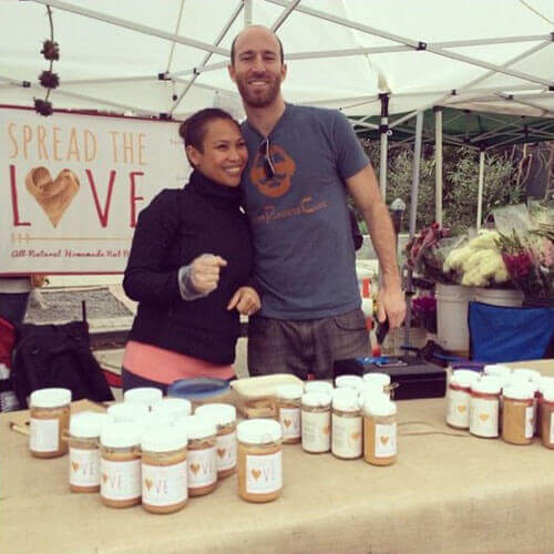 Zach and Val selling Spread The Love Peanut Butter at the farmer's  market