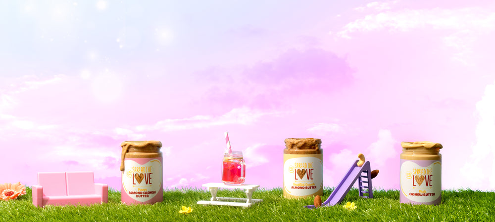 3 nut butter jars on a grassy mini playground with pink and purple sky in the background