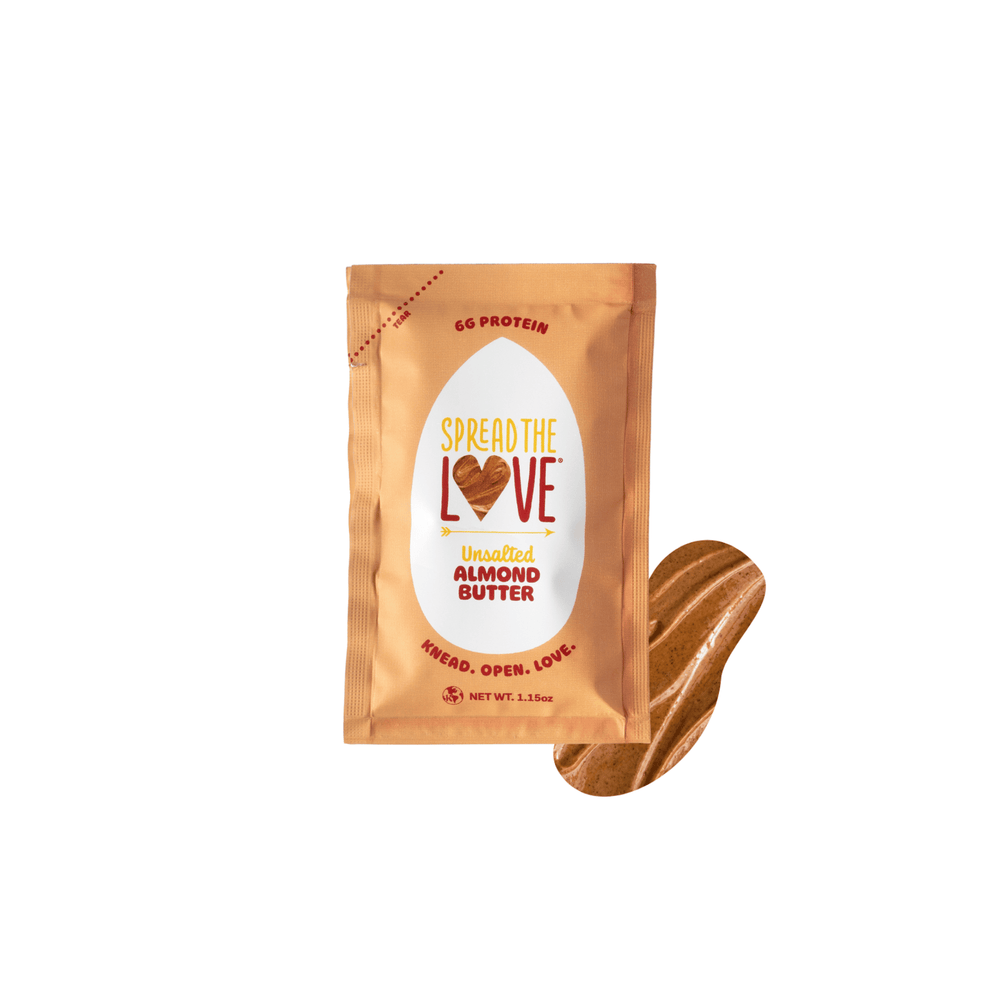 Spread The Love Almond butter packet with a spoonful of almond butter on a white background