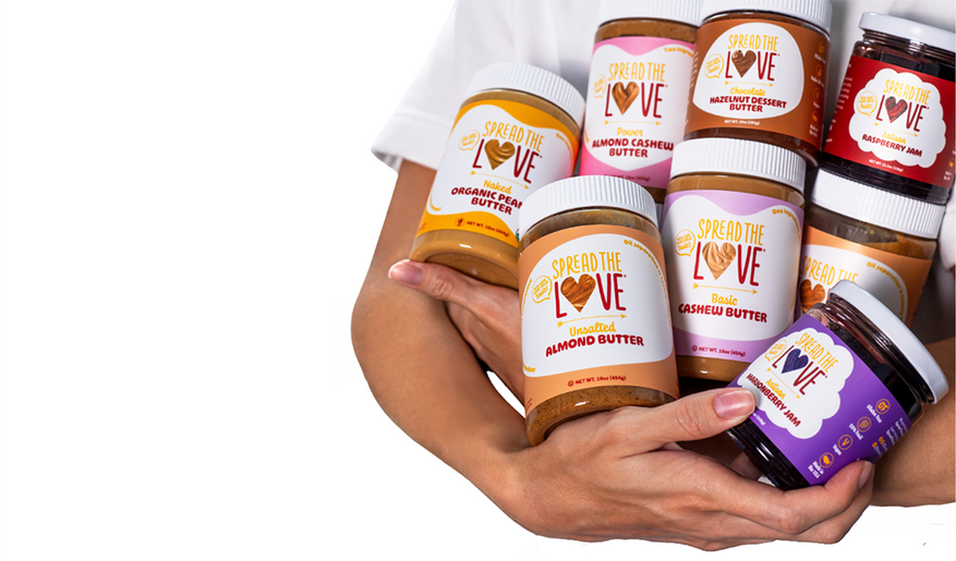 woman holding jars of nut butters and jams