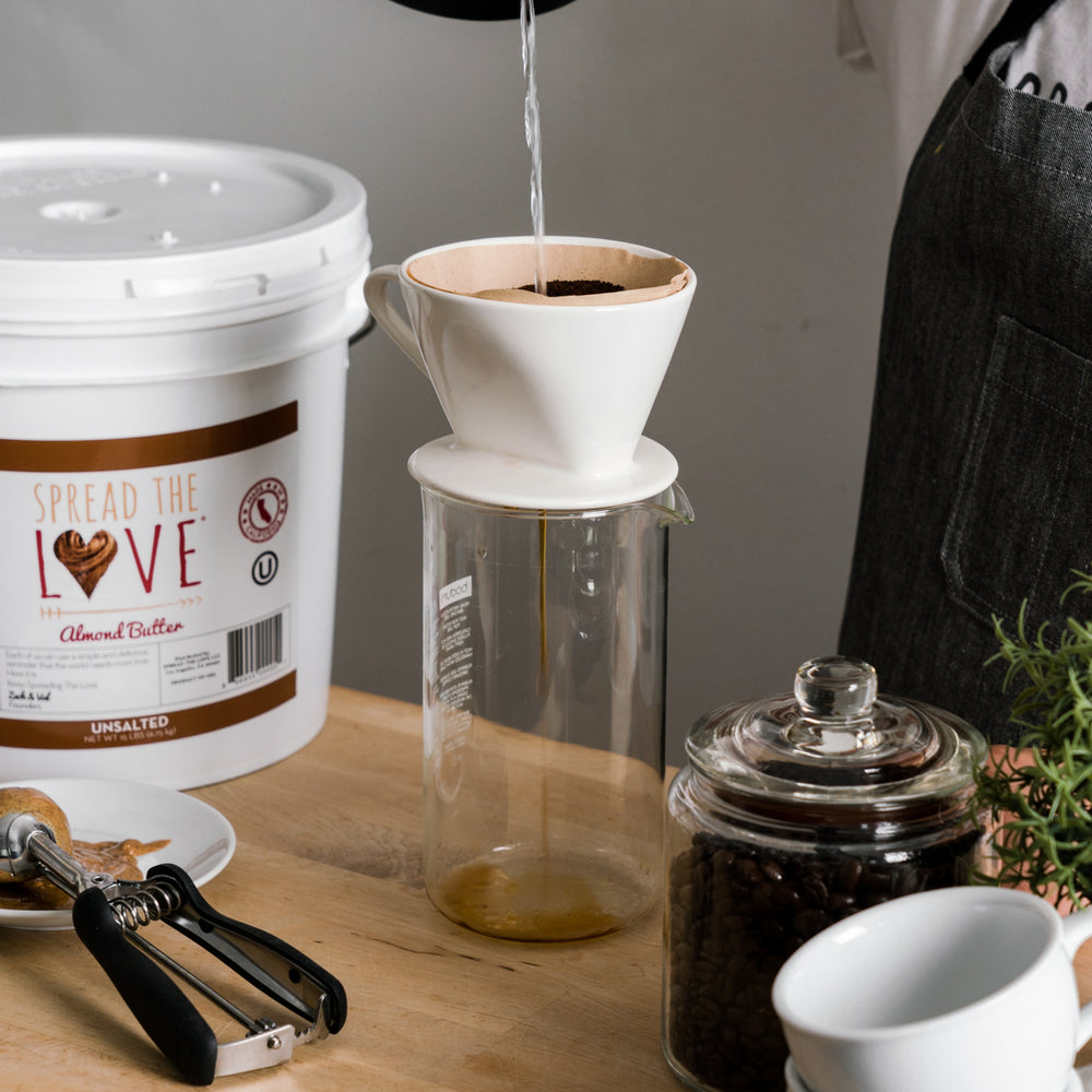 
                  
                    Load image into Gallery viewer, pread The Love Unsalted Almond Butter 40 Pound Pail on a table with a coffee maker, coffee beans, and scoop.
                  
                